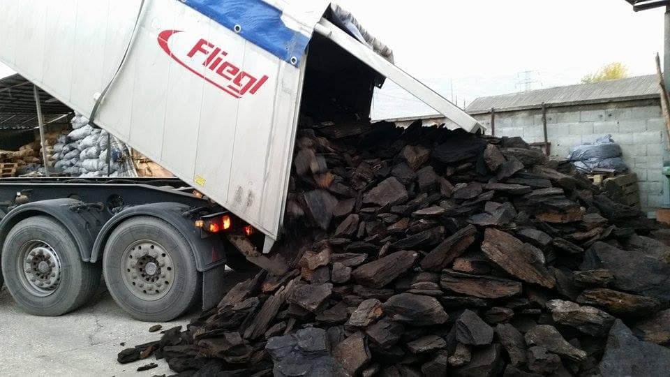 Unloading charcoal for distribution