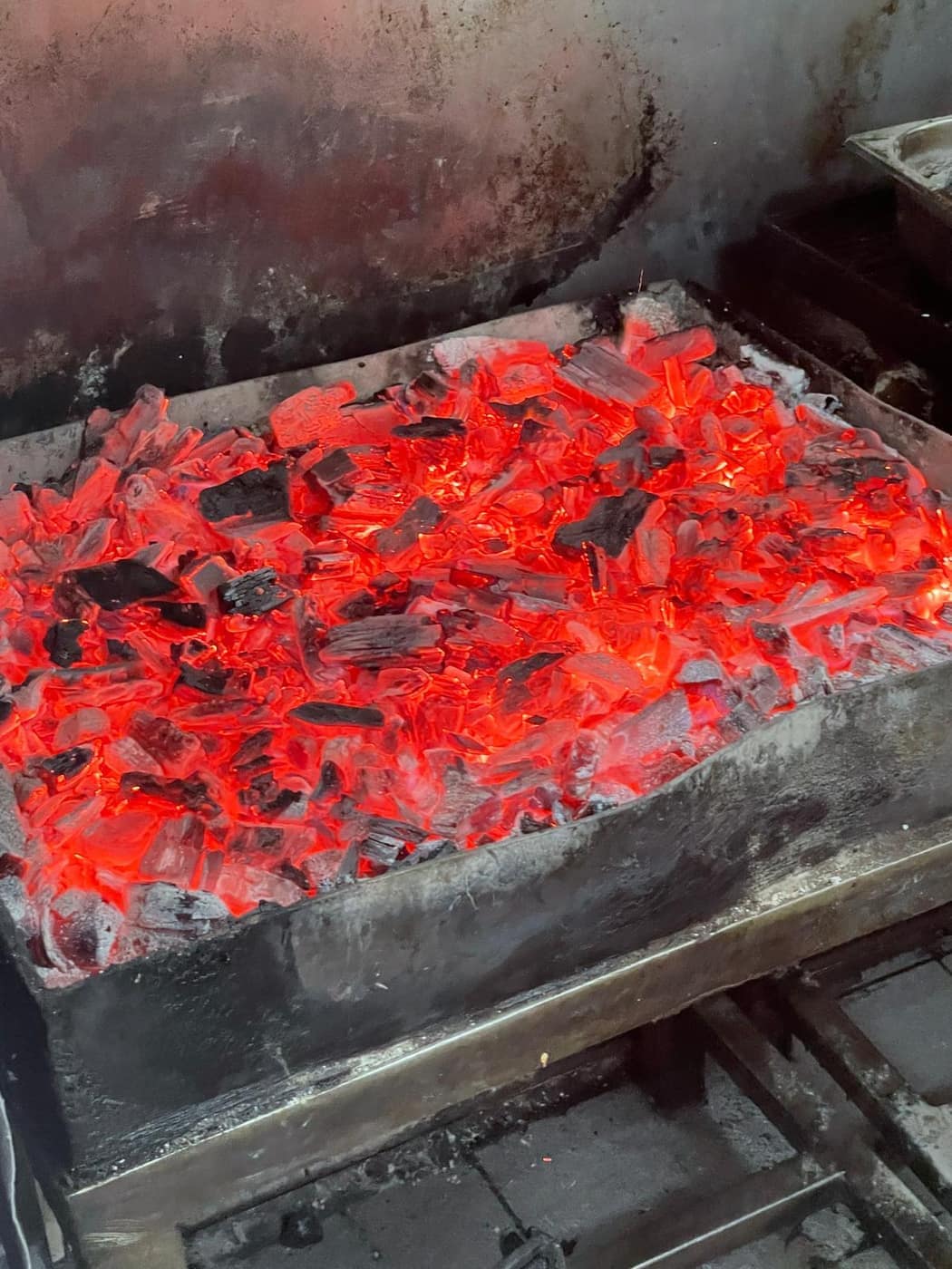 Tray of blazing charcoal embers